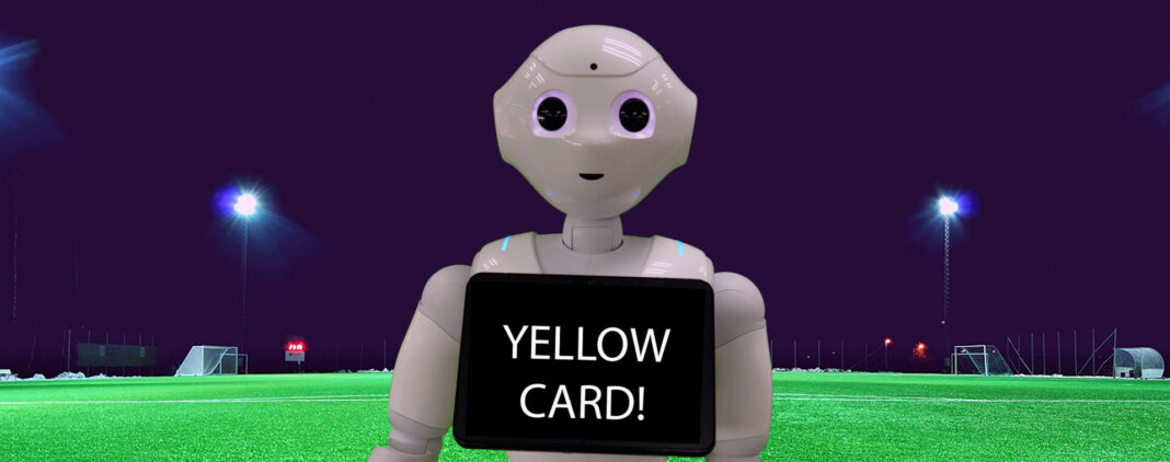 Robot on a soccer field with a screen that reads yellow card